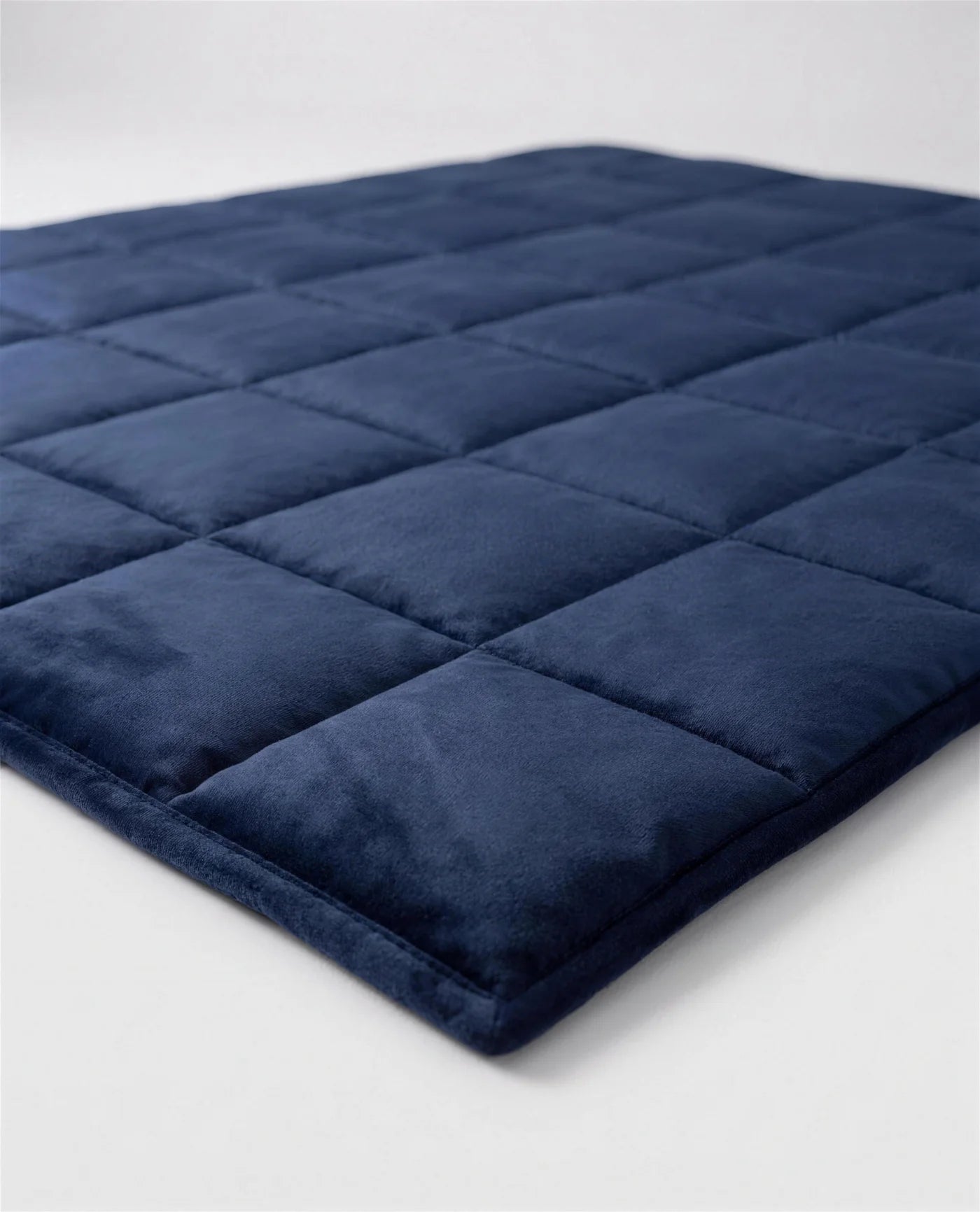 Angled close-up of the Aploomb Weighted Blanket quilted layers