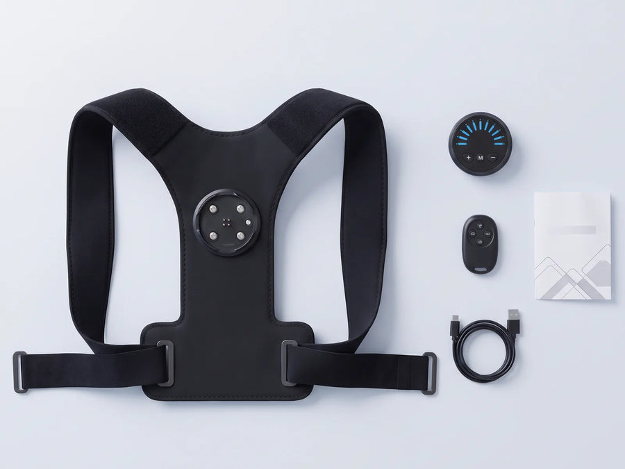 In the box: the PostureFit brace with its snap-off controller, the wireless remote, the charging cable and the instructions